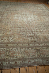 Angled view across the field of a fine antique Tabriz, highlighting the intricate cartouche main border.
