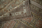 A corner of the antique Tabriz carpet folded over to show its woven foundation and reinforced selvage.