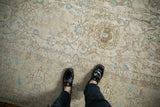 Vintage Distressed Tabriz carpet showcasing subtle ivory and sky blue floral patterns on a low pile.