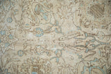 Distressed pile detail of a vintage Tabriz rug, with ivory and powder blue floral and vine motifs.