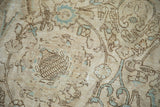 Distressed vintage Tabriz rug's beige and sky blue scrolling floral patterns show even wear.