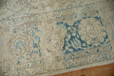 Distressed vintage Tabriz rug with blue cloudband and floral vine patterns, showing even wear.