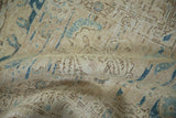 Vintage Distressed Tabriz carpet close-up, highlighting worn low pile and muted sand, ivory, and blue tones.