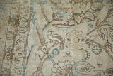 Distressed Tabriz rug texture showing a bird, scrolling vines, powder blue, and foundation wear.