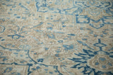 Close-up of the evenly worn pile on a vintage Heriz with blue and sand leaf motifs.