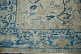 A detailed view of the Samovar cloudband border and sprawling leaf motifs of a vintage Heriz rug.