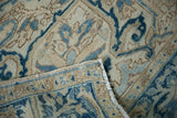 The hand-knotted construction and intact selvage of a vintage Heriz rug shown at a folded corner.
