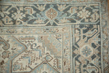 Distressed vintage Heriz carpet corner with dusty teal and ivory geometric Samovar Turtle border.
