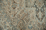 Distressed pile of vintage Heriz rug with stylized Herati floral motifs in dusty teal and ivory.