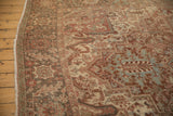 Distressed vintage Heriz rug showcasing faded raspberry red, beige, and oxidized silver patterns.