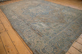 Distressed Indian Ahar carpet featuring textured Souf weave and faded blue floral tendrils on beige.