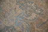 Souf weave texture on the distressed Indian Ahar carpet with blue and coffee floral motifs.