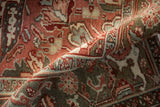 Textured pile of a vintage distressed Heriz rug, with muted cherry red and dusty olive geometric motifs.