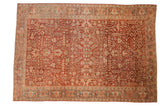 Hand-knotted Heriz carpet, distressed burgundy red field, allover palmette and geometric vine patterns.