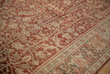 Distressed vintage Heriz carpet: deep burgundy field with geometric vines, palmettes, and Herati border.