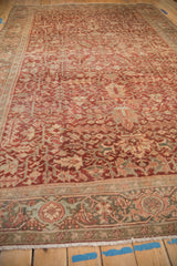 Faded burgundy and dusty teal tones in vintage Heriz carpet's Turtle Samovar border.