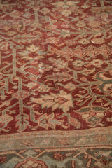 Distressed texture of Heriz carpet pile, geometric vines in burgundy, teal, beige.