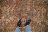 Distressed vintage Mahal carpet detail: worn terracotta pile and powder blue arabesque patterns.