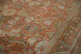 Distressed vintage Mahal rug in terracotta and green, featuring scrolling arabesques and worn texture.