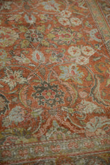 Distressed Mahal rug pile showing scrolling arabesques, faded terracotta, powder blue, and lime green.