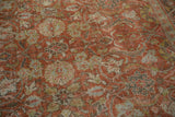 Distressed Mahal carpet displaying worn arabesques, stylized tendrils in soft terracotta and greens.