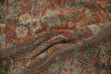 Mahal carpet detail: scrolling arabesques, faded terracotta, green, and blue tones.