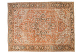 Vintage Heriz carpet, central starburst medallion, geometric blossoms, terracotta, charcoal, powder blue.