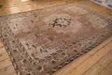Distressed vintage Kars carpet border: dusty mauve florals and coffee brown geometric spandrels.