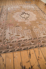 Distressed Kars carpet showing secured side cord and muted floral bouquet border.