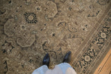 Distressed Sparta carpet showcasing serrated leaves, Turtle Samovar border, and muted earth tones.