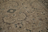 Distressed Sparta carpet detail: sprawling serrated leaves and Turtle Samovar border in beige, charcoal, coffee brown.