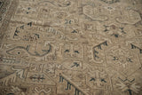 Distressed texture of the vintage Sparta carpet, showing serrated leaves in dark beige, charcoal, and coffee brown.