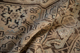 Distressed Heriz carpet detail, worn pile, geometric motifs in beige, brown, and sky blue.