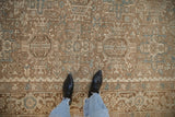 Distressed vintage Heriz rug's Karaja stylized patterns in pale brown, ivory, and powder blue.