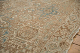 Distressed vintage Heriz rug pile, revealing Karaja stylized patterns in pale coffee and powder blue.