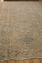 Distressed vintage Heriz rug: pale coffee, ivory, blue Karaja stylized panels, machine bound side.