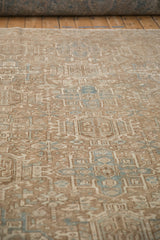 Distressed vintage Heriz carpet, Karaja stylized panels, visible even wear, pale blue accents.
