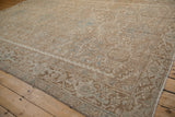 Distressed Heriz carpet showing reduced border, machine bound side, and Karaja panels.