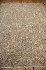 Distressed vintage Karaja rug with faded geometric panels in soft brown, ivory, and blue.