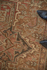 Distressed Heriz carpet with faded chestnut, dusty rose, and oxidized silver geometric motifs.