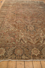 Distressed vintage Heriz carpet pile with even wear, revealing geometric patterns and dusty rose tones.