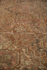 Distressed texture and faded chocolate, dusty rose geometric patterns on vintage Heriz carpet.