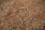 Faded Heriz carpet pattern, geometric arabesques, blossoms, dusty rose, and chocolate brown.