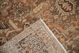 Corner of distressed Heriz carpet, showing faded pile and intricate hand-knotted reverse.