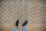 Soft, low pile texture of a distressed Persian rug with a Herati pattern in terracotta and blue.