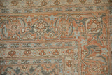Intricate Samovar Turtle border in terracotta, blue, and silver on a distressed vintage rug.