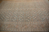Expansive view of the distressed Tabriz carpet highlighting the Samovar Turtle border and soft colors.