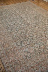 Angled view of a vintage Tabriz rug showing the soft, even wear across its muted allover pattern.