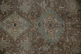 Karaja style medallions in dusty blue and brown on the low, even pile of a vintage Heriz carpet.