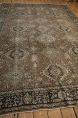 Low angle view of the vintage Heriz carpet's even wear over its stylized geometric medallions.